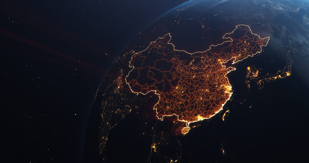 Satellite view of China at night, highlighting city lights and the country's outline